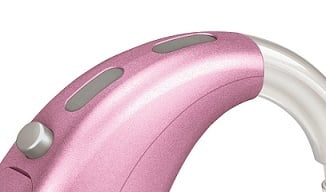 Close-up of a pink behind-the-ear hearing aid with a silver button and gray accent, featuring the Phonak Wind and Weather Protector (Short), on a white background.