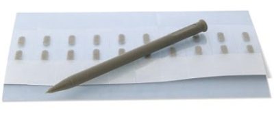 A brown dental implant healing cap tool sits on a white strip, resembling a Phonak Wind and Weather Protector (Short), with several cylindrical caps neatly arranged in rows.